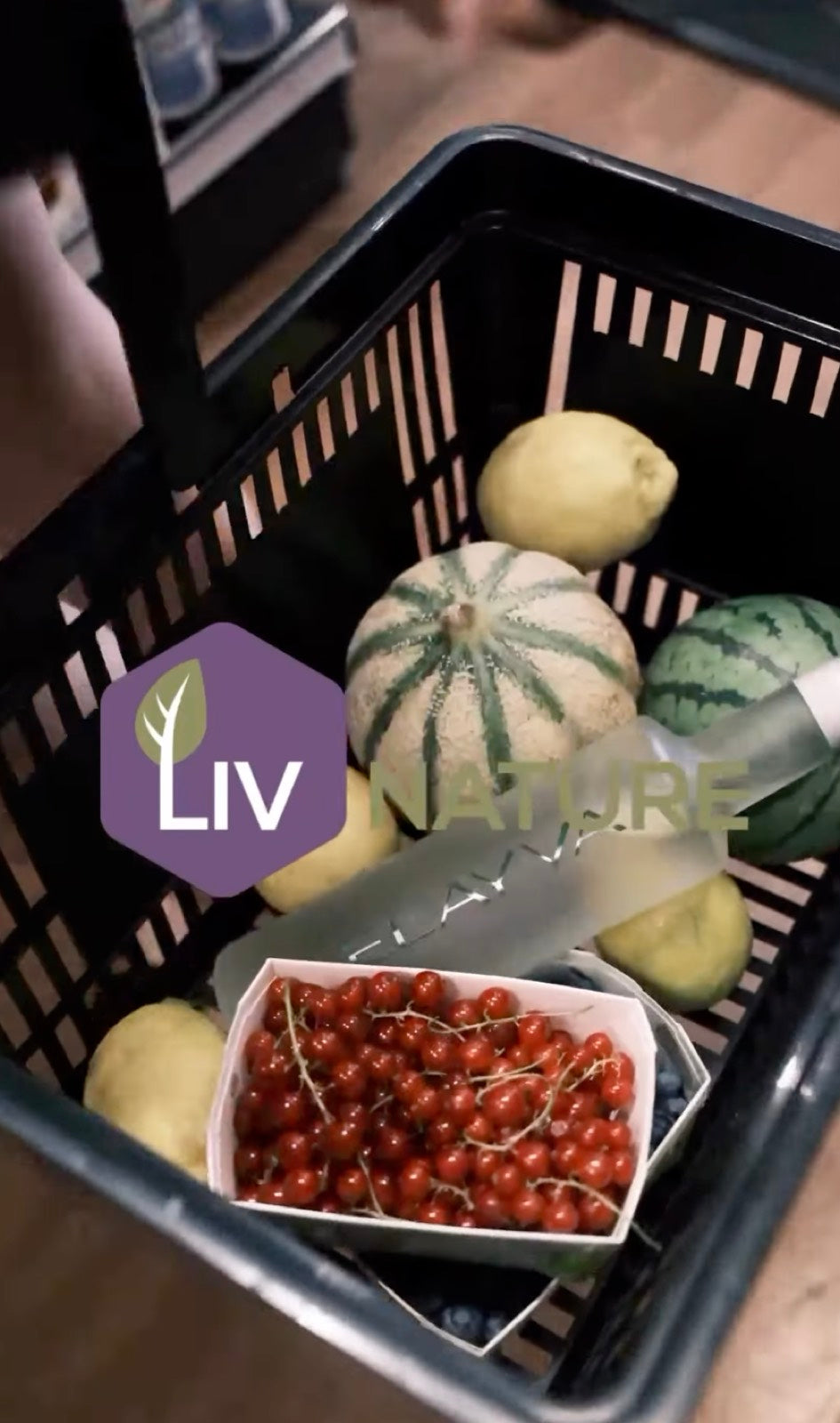 ELAYVA bottle in a wicker basket with fresh produce