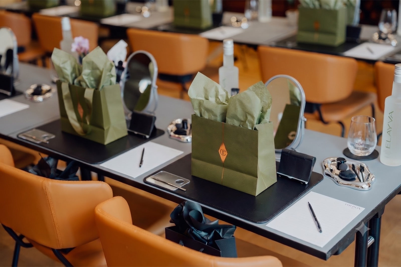 ELAYVA shopping bags on a table in a warm lounge interior