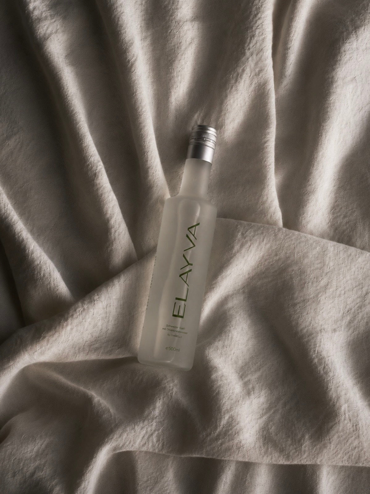 ELAYVA bottle resting on soft fabric